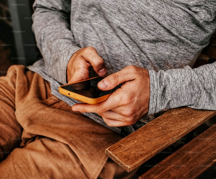 image of male social entrepreneur holding a mobile phone for How to do newspaper advert for Change Trustees of An Incorporated Trustee (NGO) with its newspaper publication